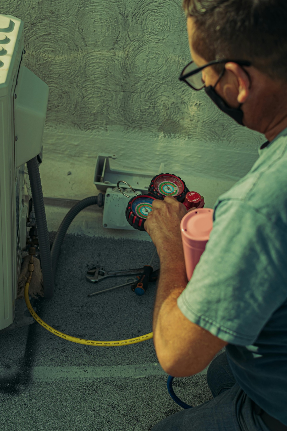 Technician checking HVAC service gauges